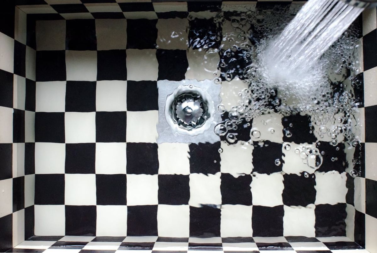 Water pooling around the drain in a kitchen sink