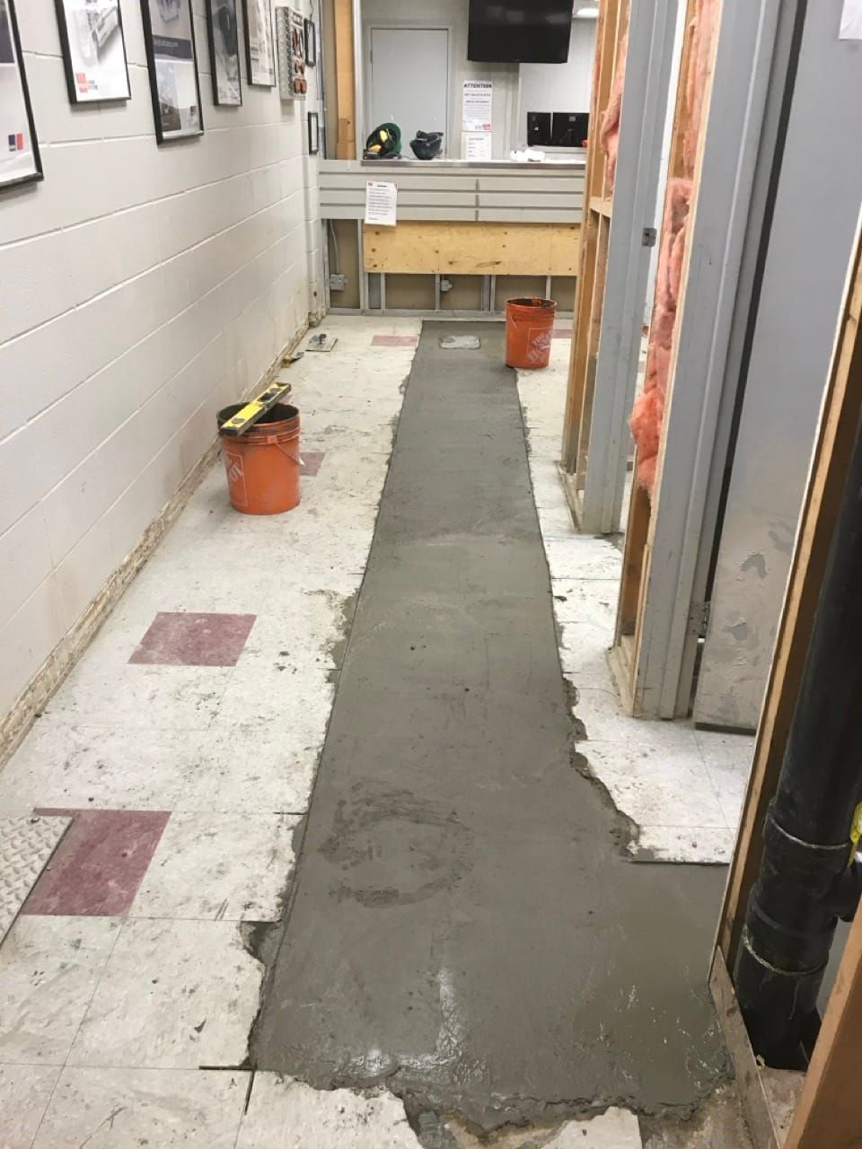 Fresh concrete over a new sewer line in the Wajax heavy-duty industrial shop